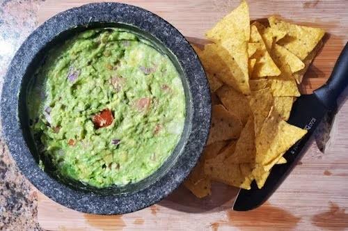 A fresh bowl of cannabis infused guacamole and tortilla chips.