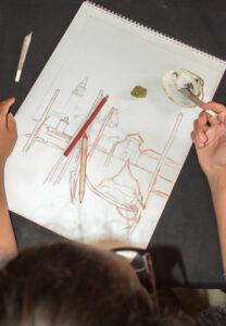 Woman smoking a marijuana joint during a break after drawing